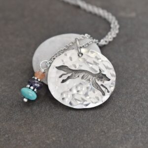 silver coin shap pendant with fox and gemstone charm