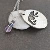 oval pendant with walking black bear and with amethyst gemstones