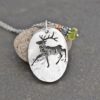 a elk pendant with gemstone charm