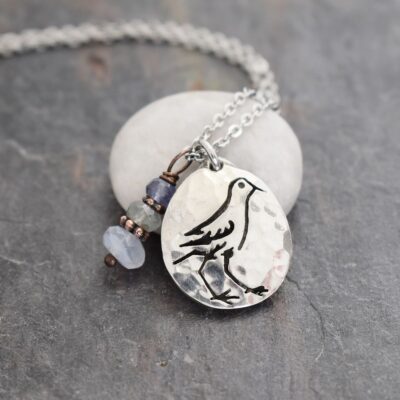 Silver sandpiper seabird pendant with blue and gray gemstone charm