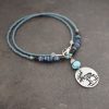 Beaded Moose in water with blue kyanite
