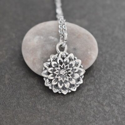 Close-up of a 3D silver pewter dahlia flower pendant on a stainless steel chain."