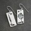 long rectangles with a pine tree and aspen tree on them