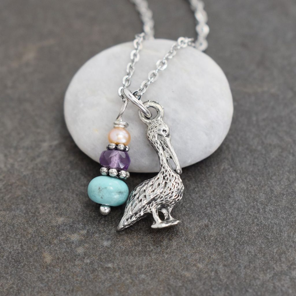 silver 3d pelican bird with peach, purple and turquoise gemstones