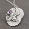 Oval pendant with flying duck with lavender gemstones and pearl