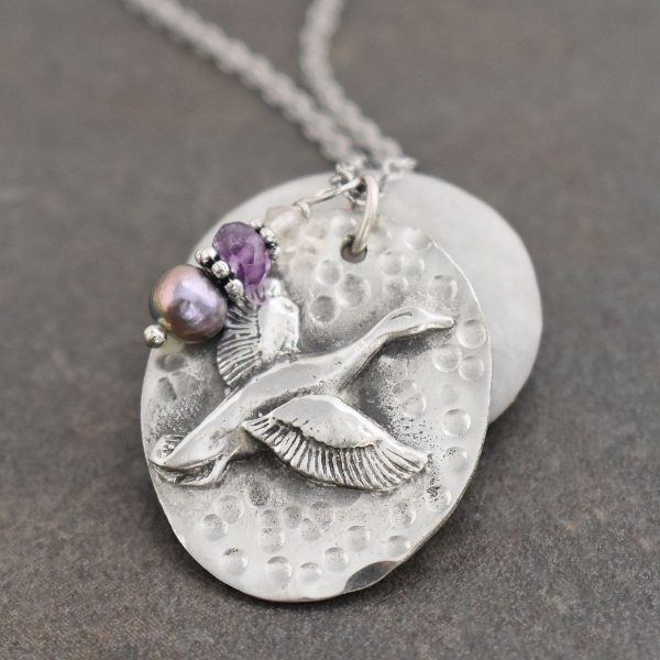 Oval pendant with flying duck with lavender gemstones and pearl