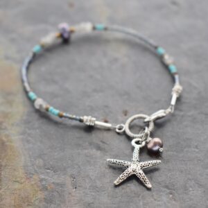 Thin beaded bracelet with gray gemstones, and pearls with silver 3d starfish charm