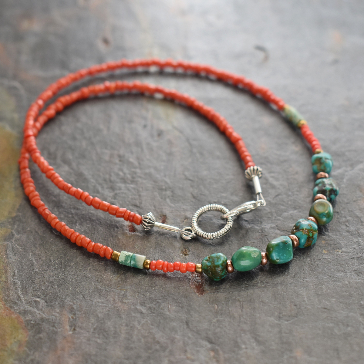 Beaded necklace with red coral dainty beads and turquoise nugget with copper spears beads.