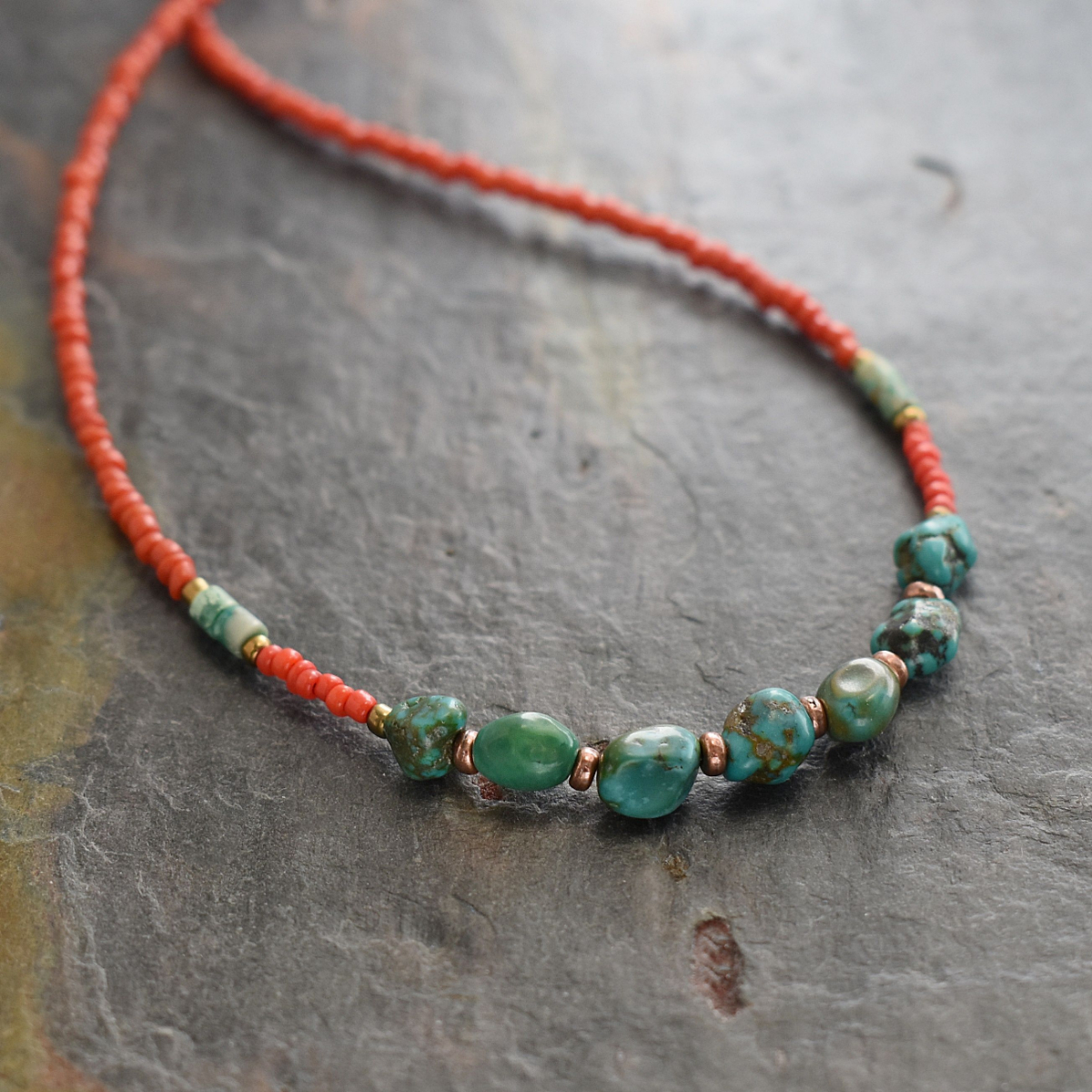 Beaded necklace with red coral dainty beads and turquoise nugget with copper spears beads.