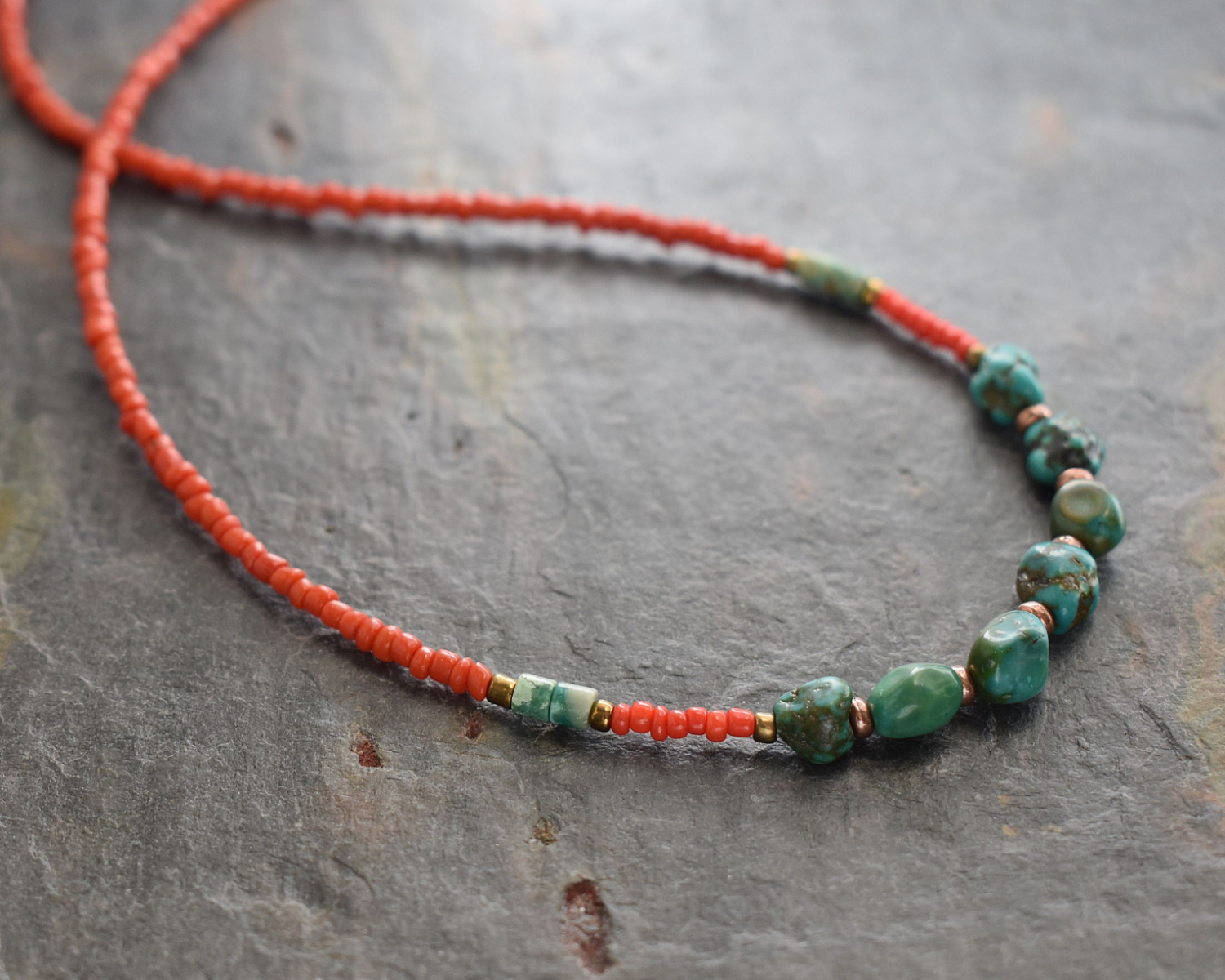Beaded necklace with red coral dainty beads and turquoise nugget with copper spears beads.