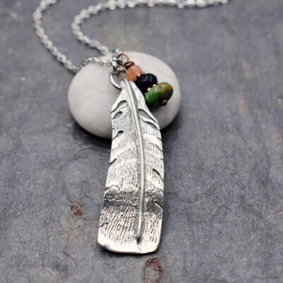 Main shot of necklace Handmade turkey feather charm necklace with natural sunstone, iolite and turquoise gemstones