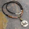 beaded black Crow necklace Beaded necklace with small black beads with black, brown, pink tourmaline gemstones with silver round pendant with flying crow