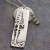 ponderosa pine tree with gemstone necklace silver rectangle with 3d ponderosa pine tree on it with green and golden yellow gemstone charm on chain