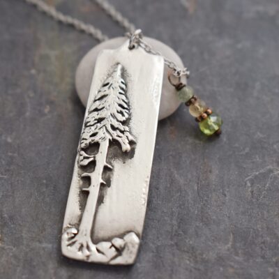 ponderosa pine tree with gemstone necklace silver rectangle with 3d ponderosa pine tree on it with green and golden yellow gemstone charm on chain