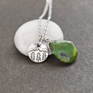 silver coin shape pendant with tiny mountian with green drop turquoise gemstone