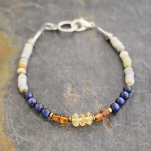 Handcrafted light blue amazonite, navy blue lapis, and cramel brown hessonite garnet beaded gemstone bracelet.