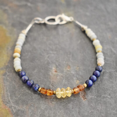 Elevate your style with our handcrafted Amazonite, Lapis Lazuli, and Hessonite Garnet bracelet. Real gemstones meet golden accents. Handmade in Colorado. Shop now Handcrafted light blue amazonite, navy blue lapis, and cramel brown hessonite garnet beaded gemstone bracelet.
