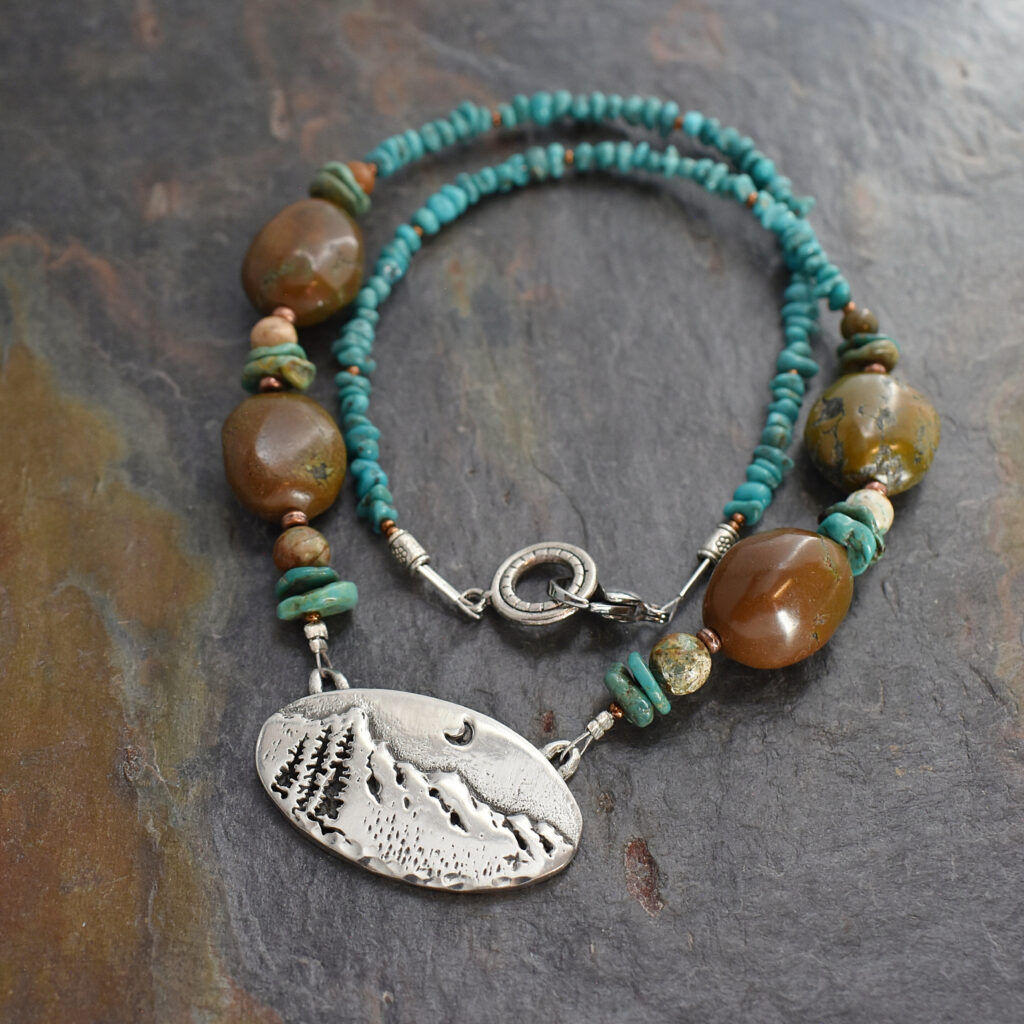 beaded blue and brown turquoise chunky gemstone necklace with a silver pewter mountain pendant