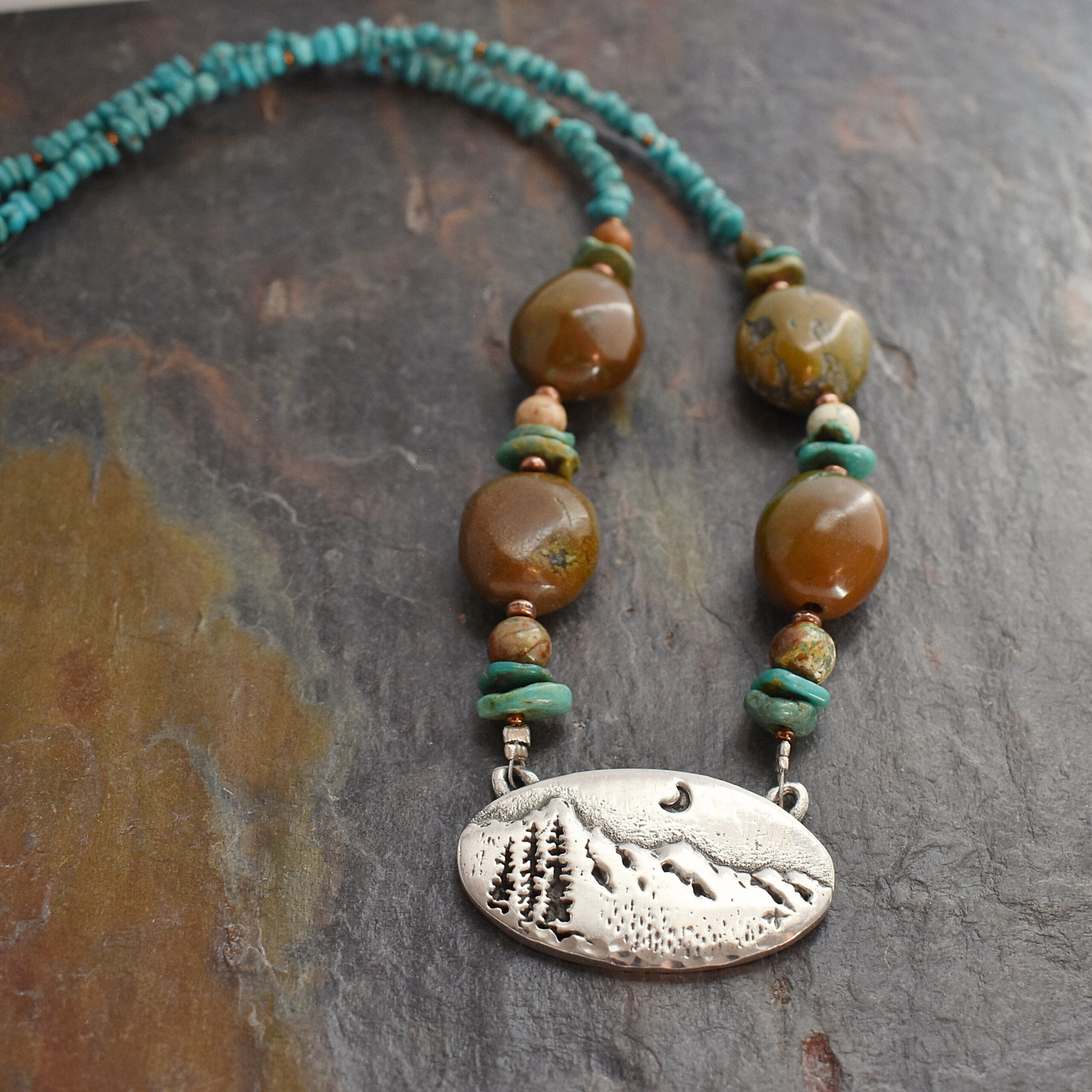 beaded blue and brown turquoise chunky gemstone necklace with a silver pewter mountain pendant