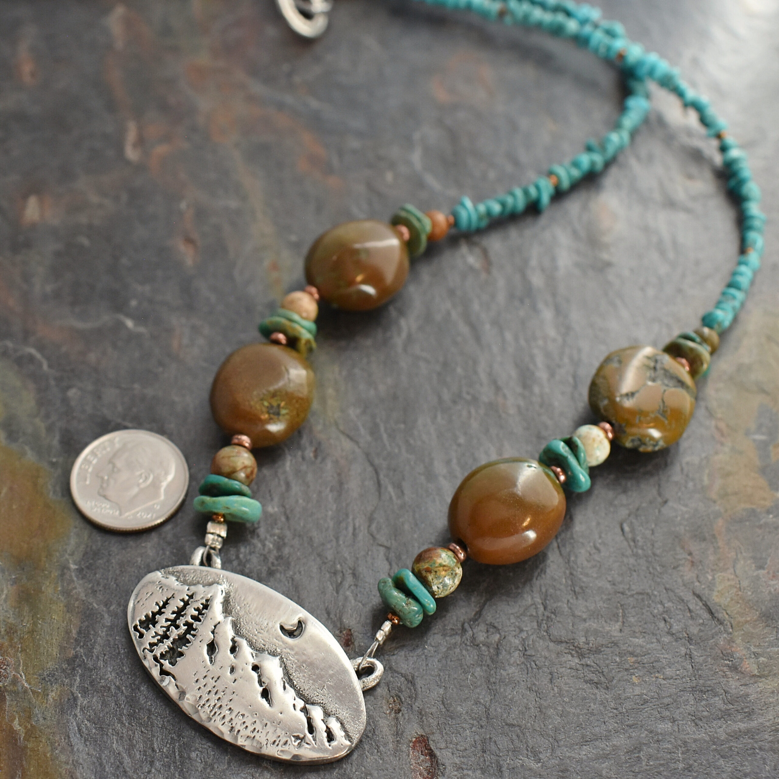 beaded blue and brown turquoise chunky gemstone necklace with a silver pewter mountain pendant