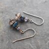 Handmade Tanzanite Sapphire Smoky Quartz Gemstone Earrings Handmade gemstone earrings with lavender blue tanzanite, dark blue sapphire, and brown smoky quartz stones with copper spacers.