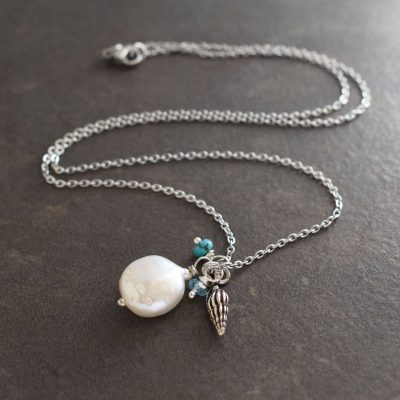 Wentletrap seashell with green coin pearl and gemstone pendant Small seashell with green coin pearl and blue gemstone pendant